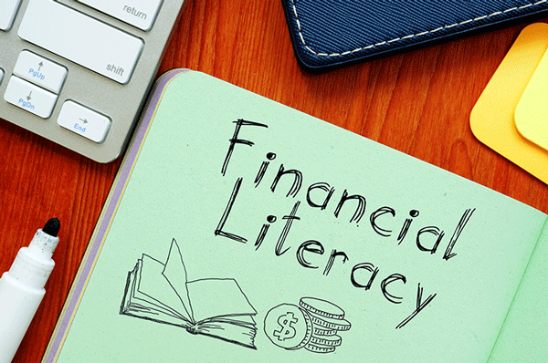 Notepad with words "financial literacy" promoting money management skills