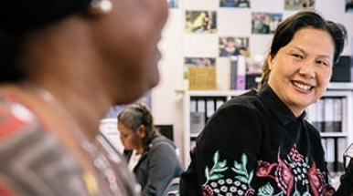 Happy older female student in class