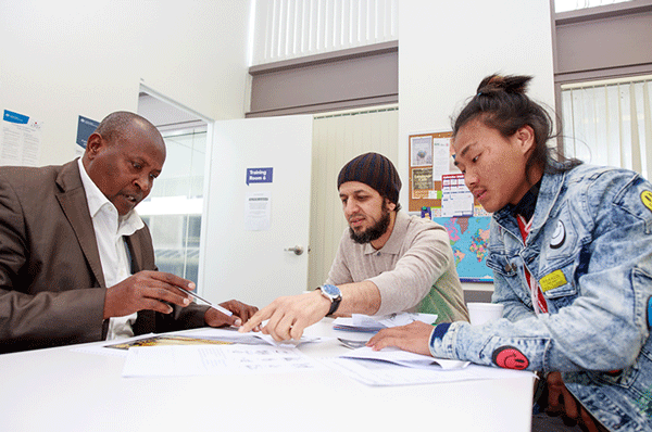 Ali studies English in a classroom with other students