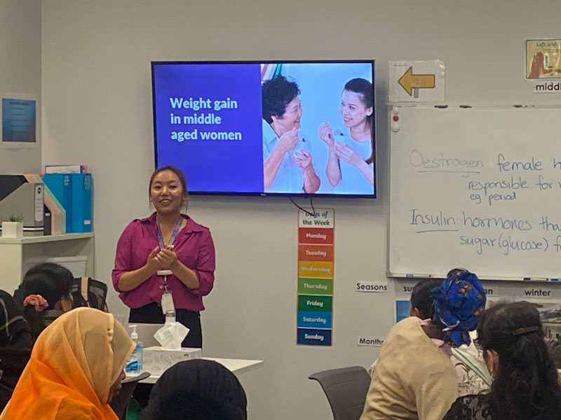 Female MAX employee delivering a women's health class