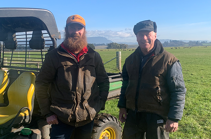 Lee and George stand side by side on the farm