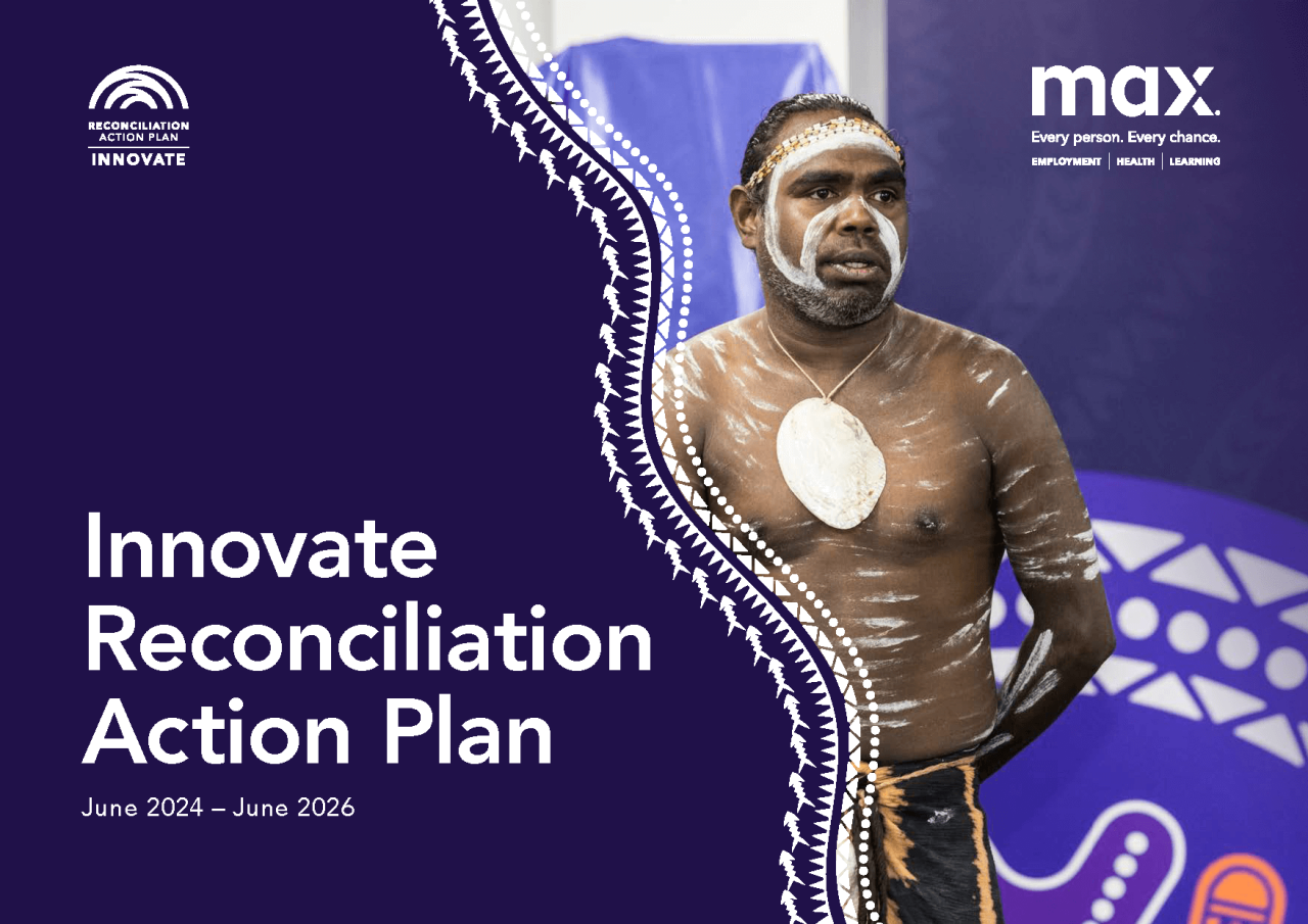 Front cover of the RAP document showing an Indigenous man at a welcome to country event. 