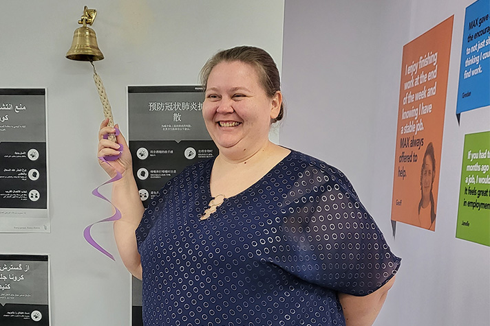 Susan smiles as she "rings the bell" to celebrate getting a job. 