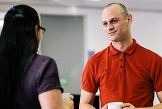 Customer in site drinking tea with team member