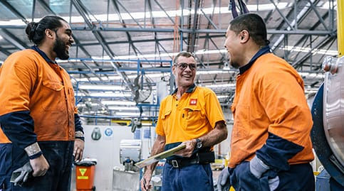 Laughing team members in hi vis in work site