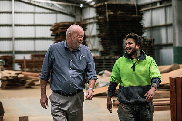 Friendly staff member and customer in timber yard