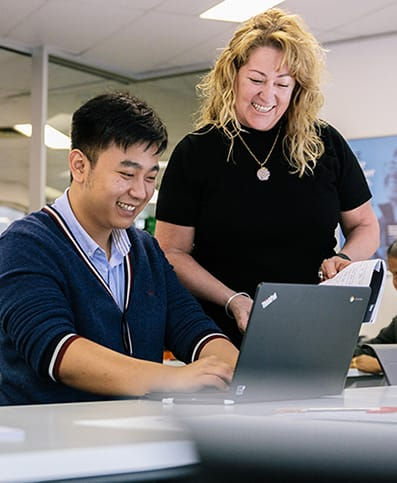 Happy student and trainer in classroom