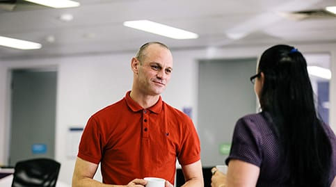 Customer in site drinking tea with team member