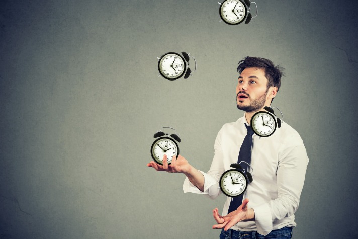 business man successfully juggling managing his time - time management article image