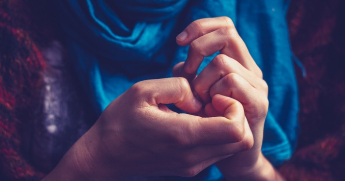 Close up on a young woman's hands as she is picking her nails anxiety article image