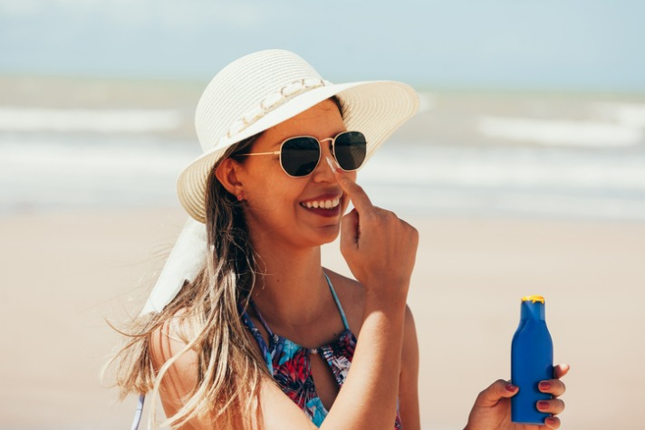 sunscreen-sunblock-woman-putting-solar-cream-on-nose-smiling-summer-picture-Why Vitamin D is important  article
