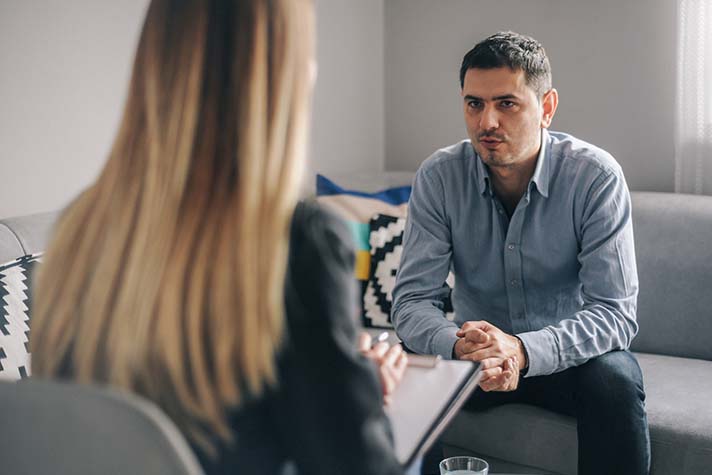 Man in counselling session with counsellor