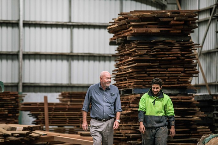 managing depression at work image - co-workers having a discussion while walking through a warehouse