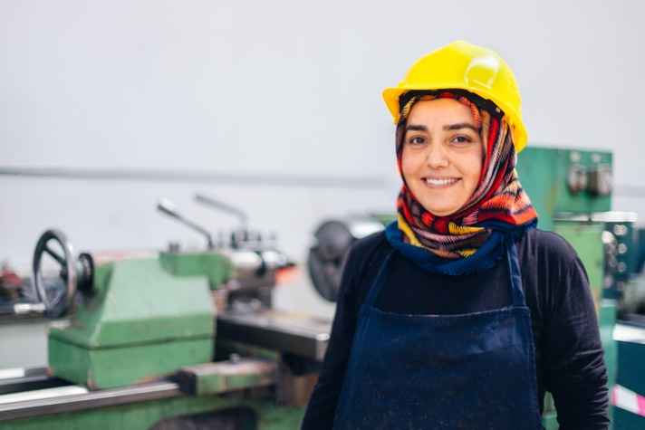 migrant support services - islamic lady working in factory