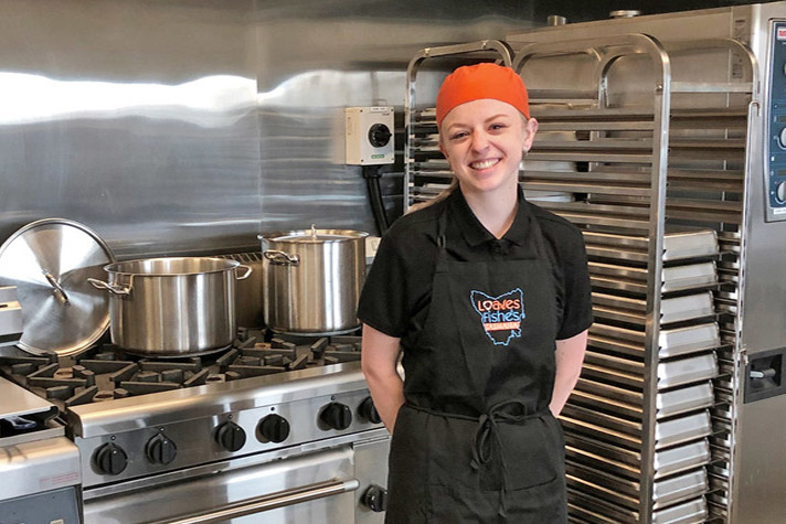 Shanaye Marshall - smiling female customer working in commercial kitchen