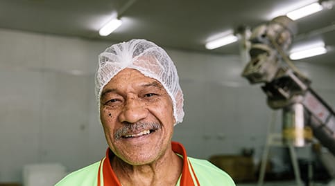 Employee in food preparation looking happy